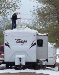 Our campground neighbor clearing snow from the top of his RV. 